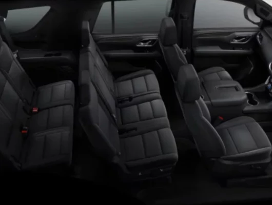 An overhead view of the three rows of black leather seating inside a Chevrolet Suburban
