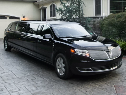 Black stretch limousine parked in a luxury residential driveway, ideal for Phoenix limo service and special events.