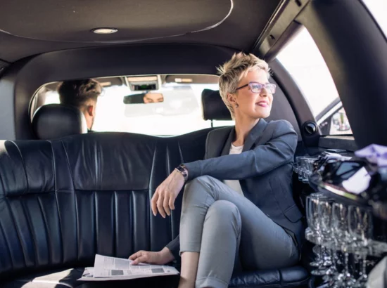 A business woman sitting in a luxury limousine